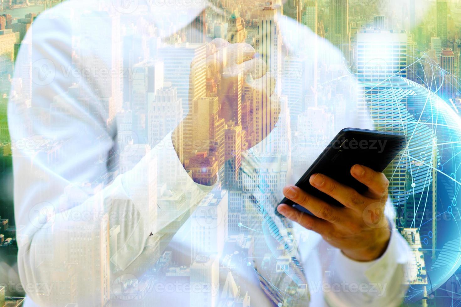 businessman using a smartphone and Businessman working on digital network with double exposure photo