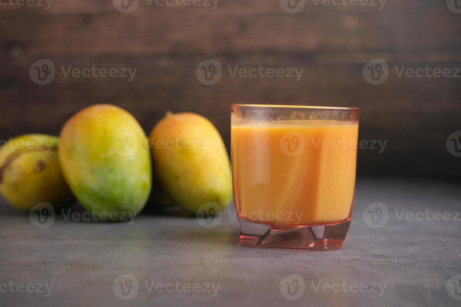 fresh mango juice with milk in a glass on table photo