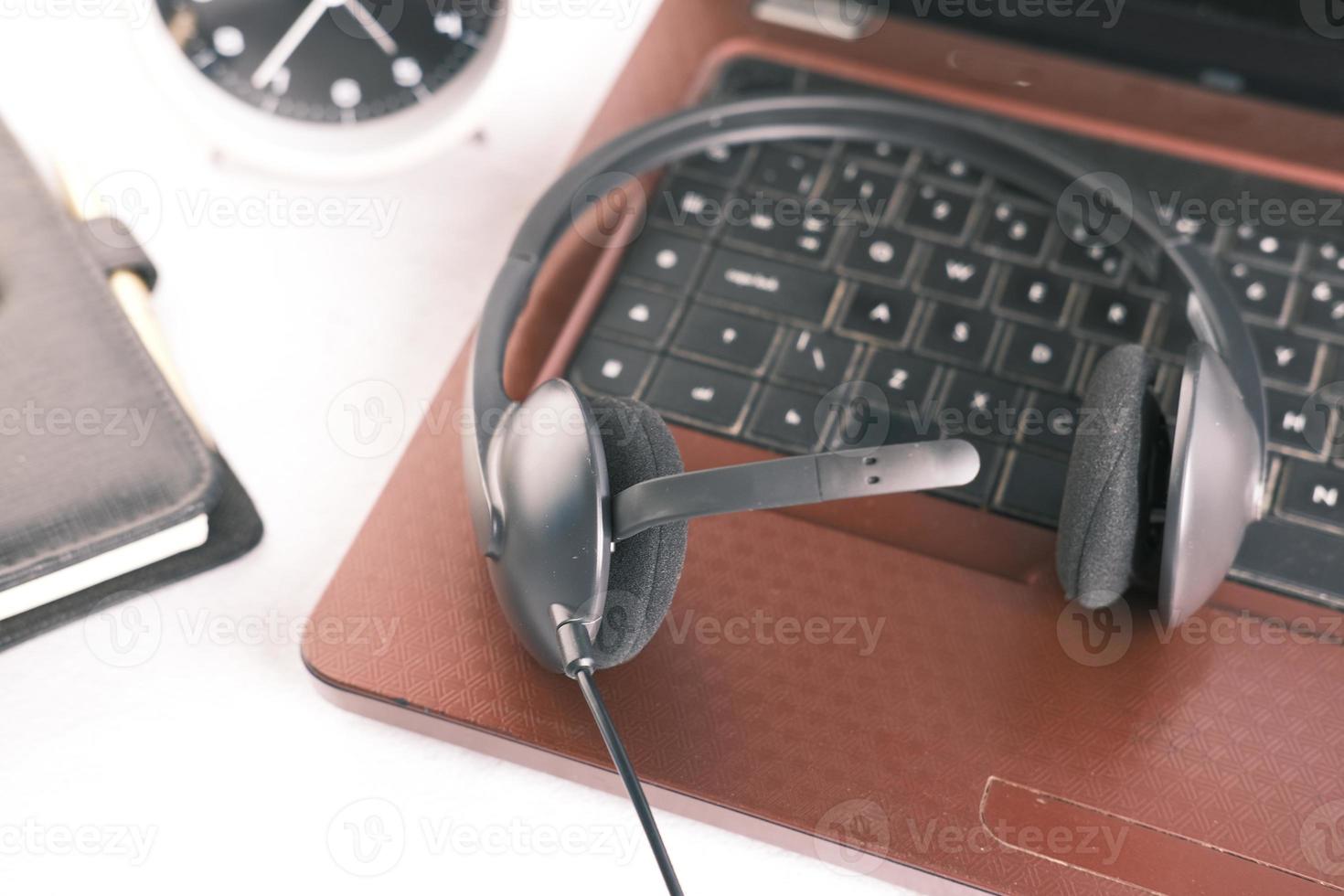 call center headphone on laptop on table , photo