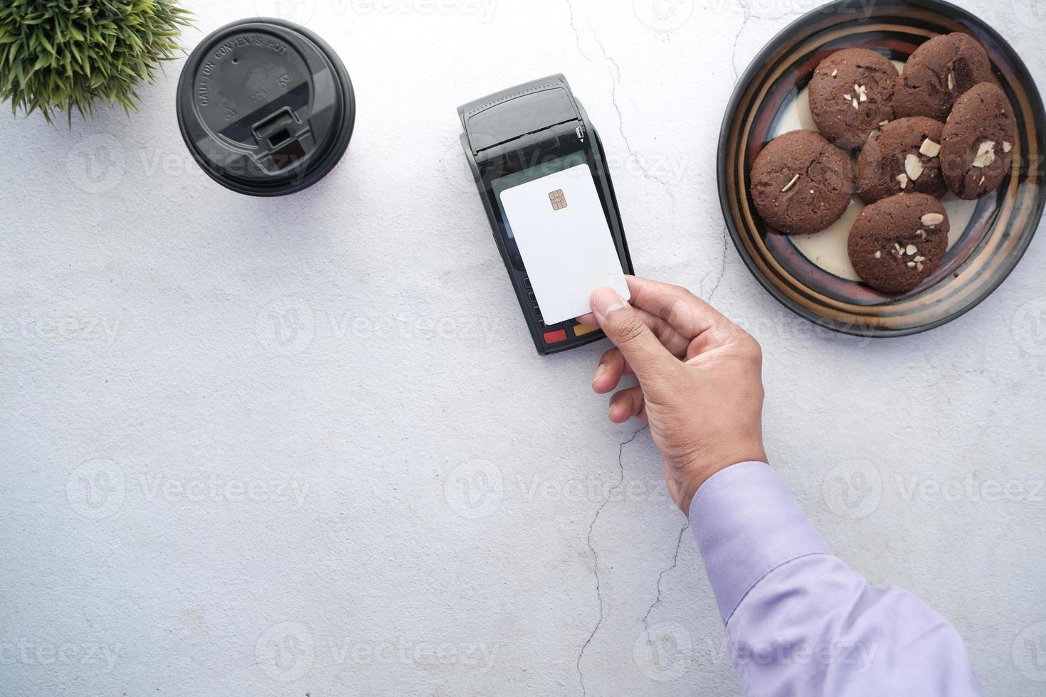 contactless payment concept with young man paying with credit card photo