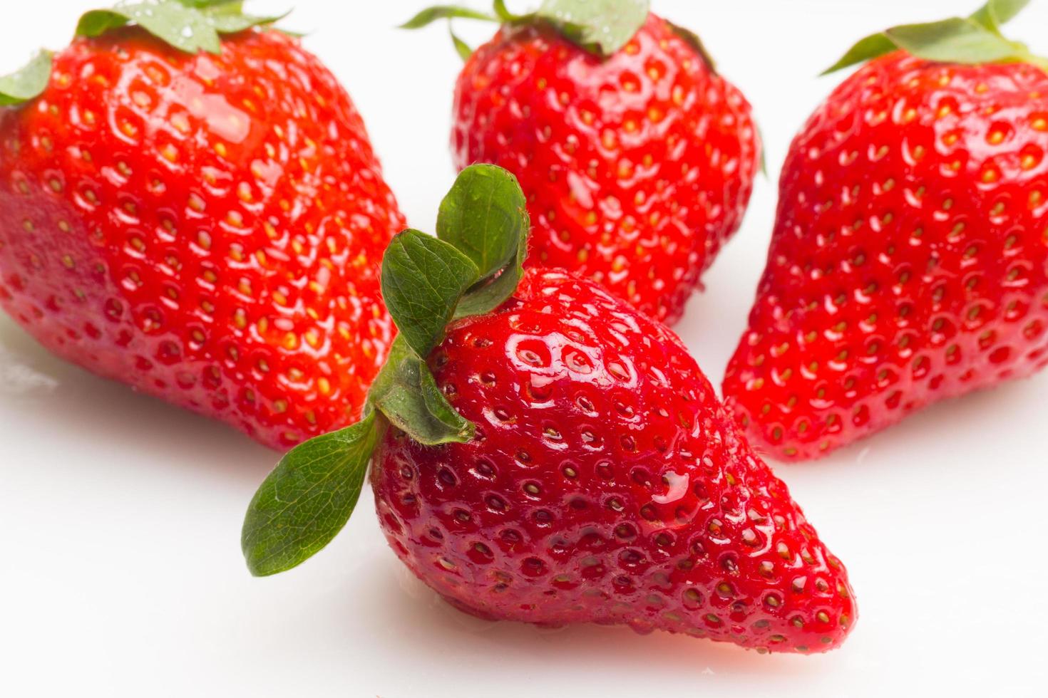 Two strawberries close up on white background photo