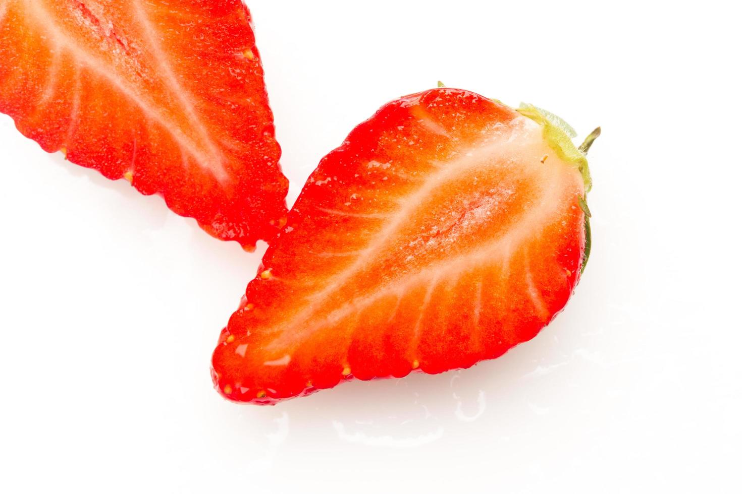 Two strawberries close up on white background photo