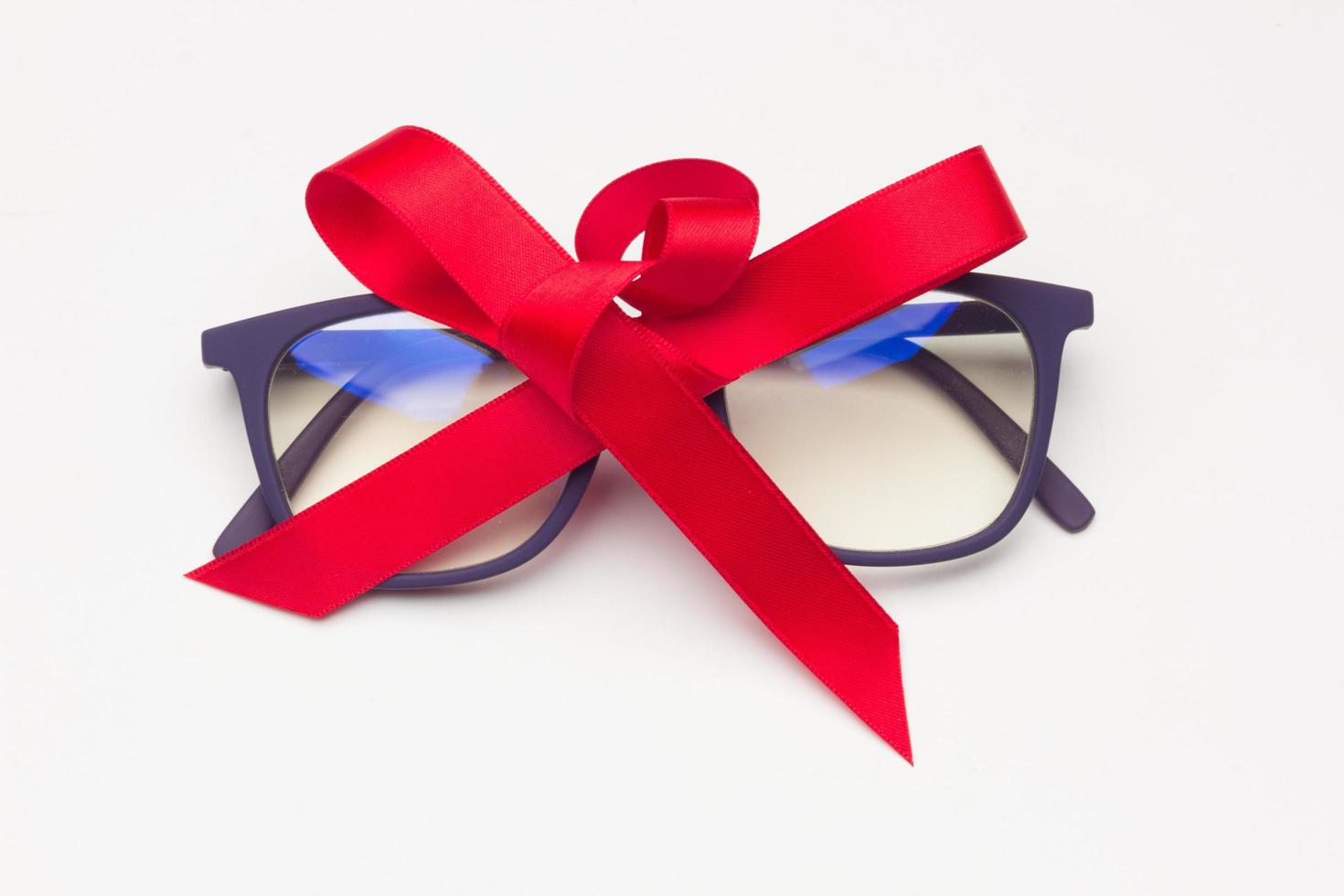 Black plastic glasses with a red bow photo