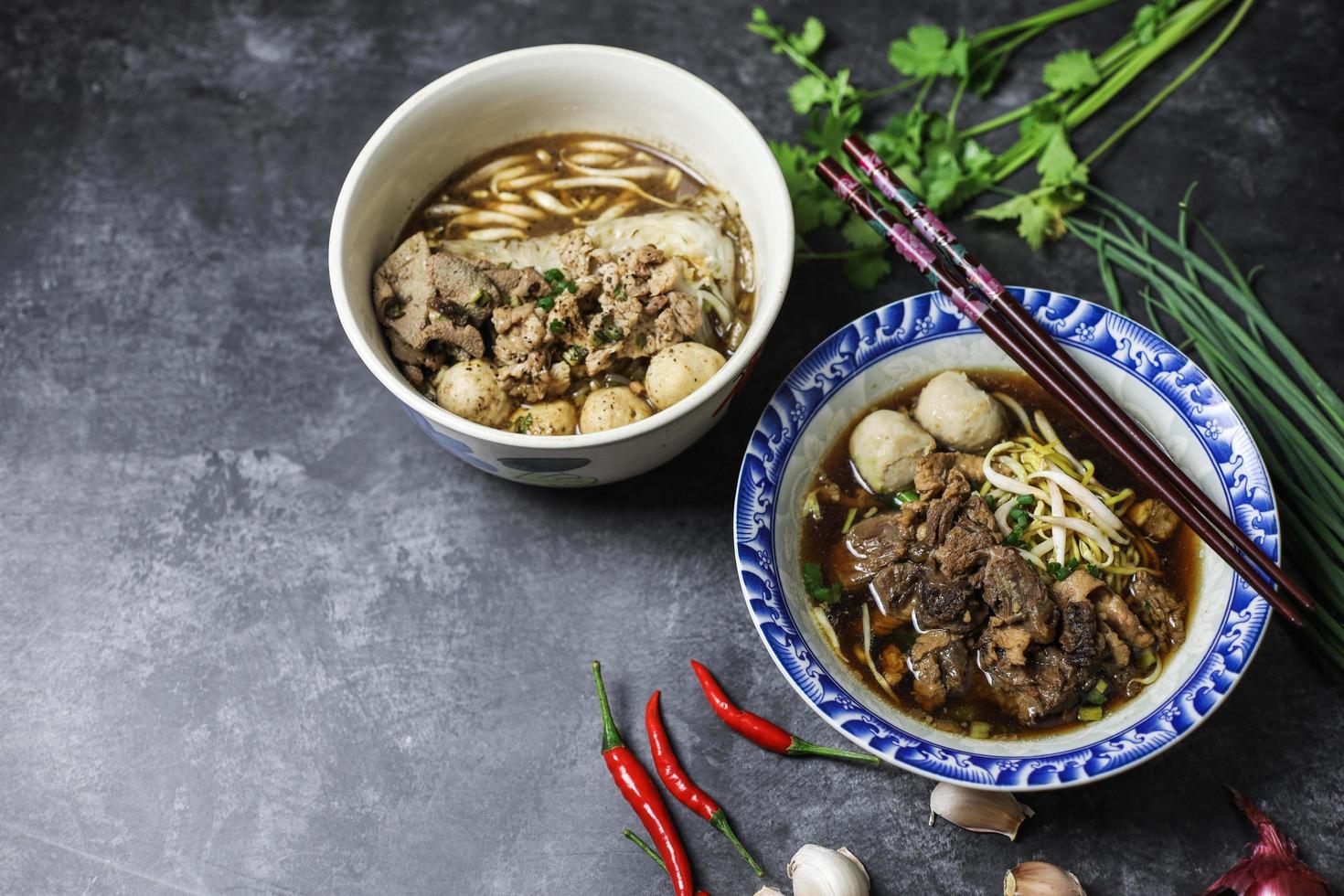 Thai boat noodles is Thailand's most famous noodles soup,Thai Boat noodles soup or Guay tiew reua ,Rice noodles thicken soup with stewed pork and pork ball, Braised pork and liver pork, photo