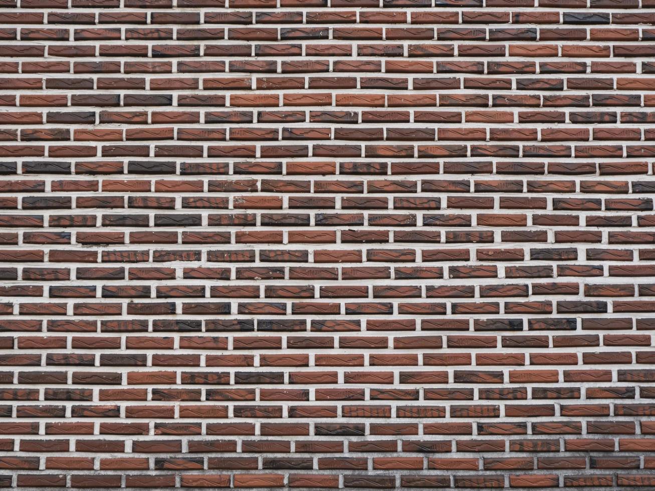 Dark red brick wall as a background texture photo