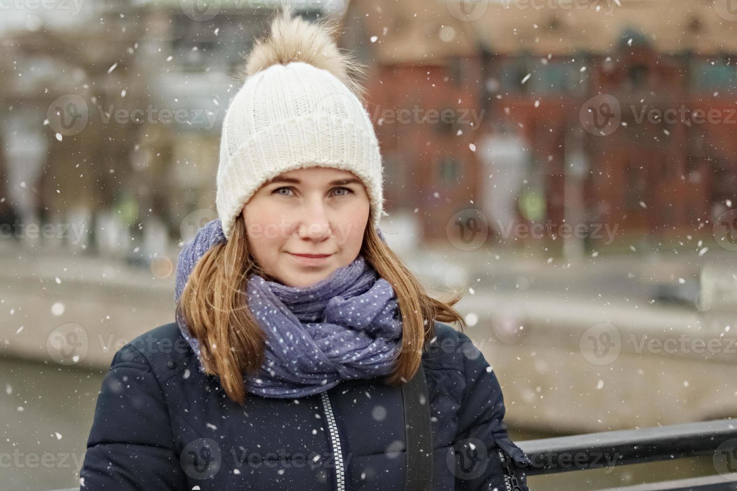 Portrait of a young beautiful happy smiling girl on the background of the city photo