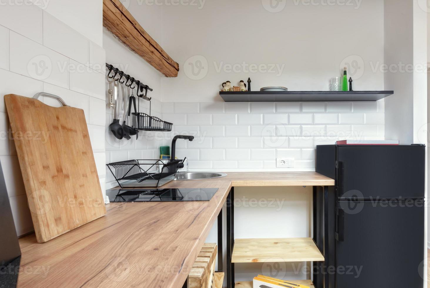 Attic apartment, modern kitchen, apartment interior design with old rustic wooden beams and furniture, stylish Italian granite ceramica. photo