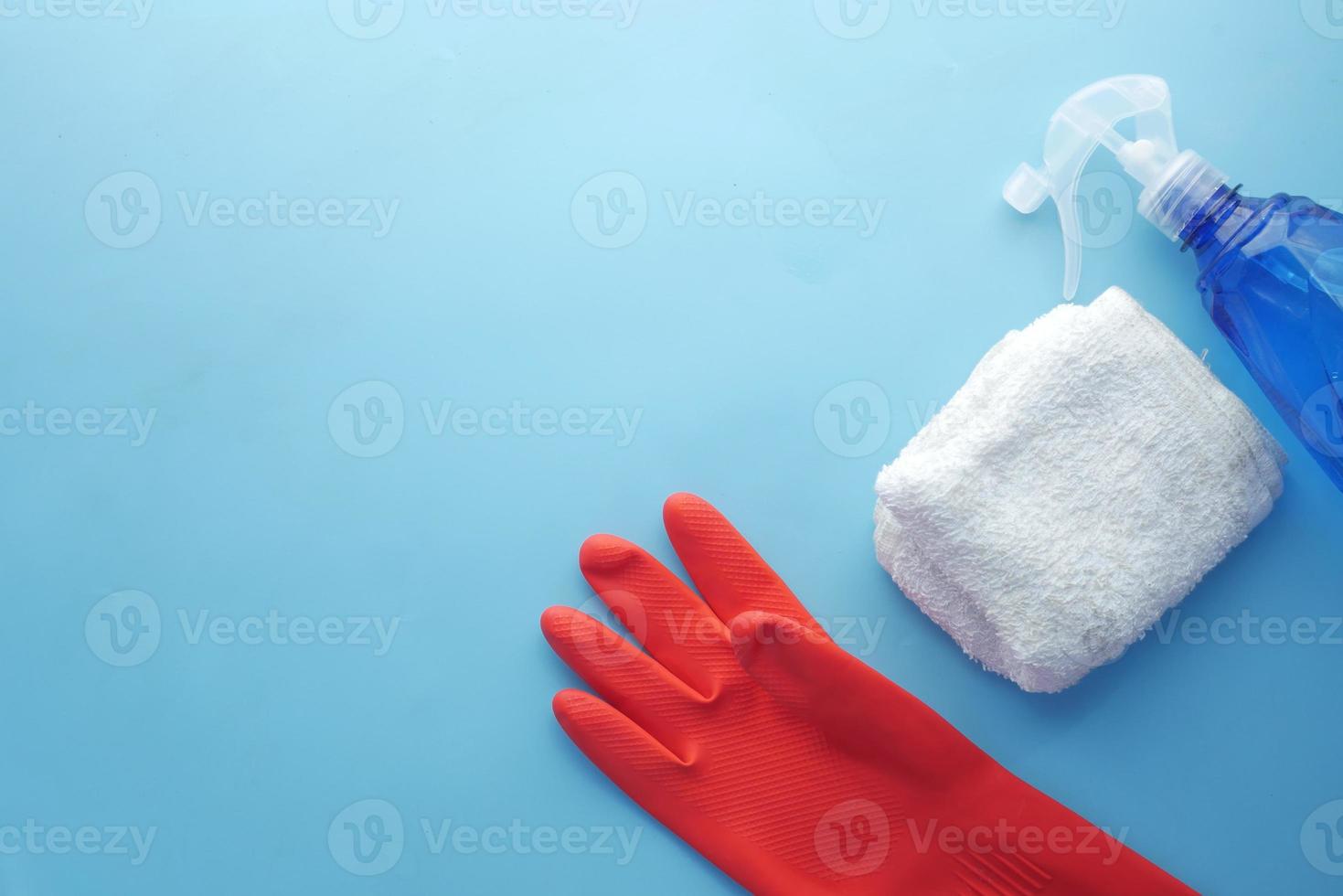 Spray bottle and cleaning cloth on table photo