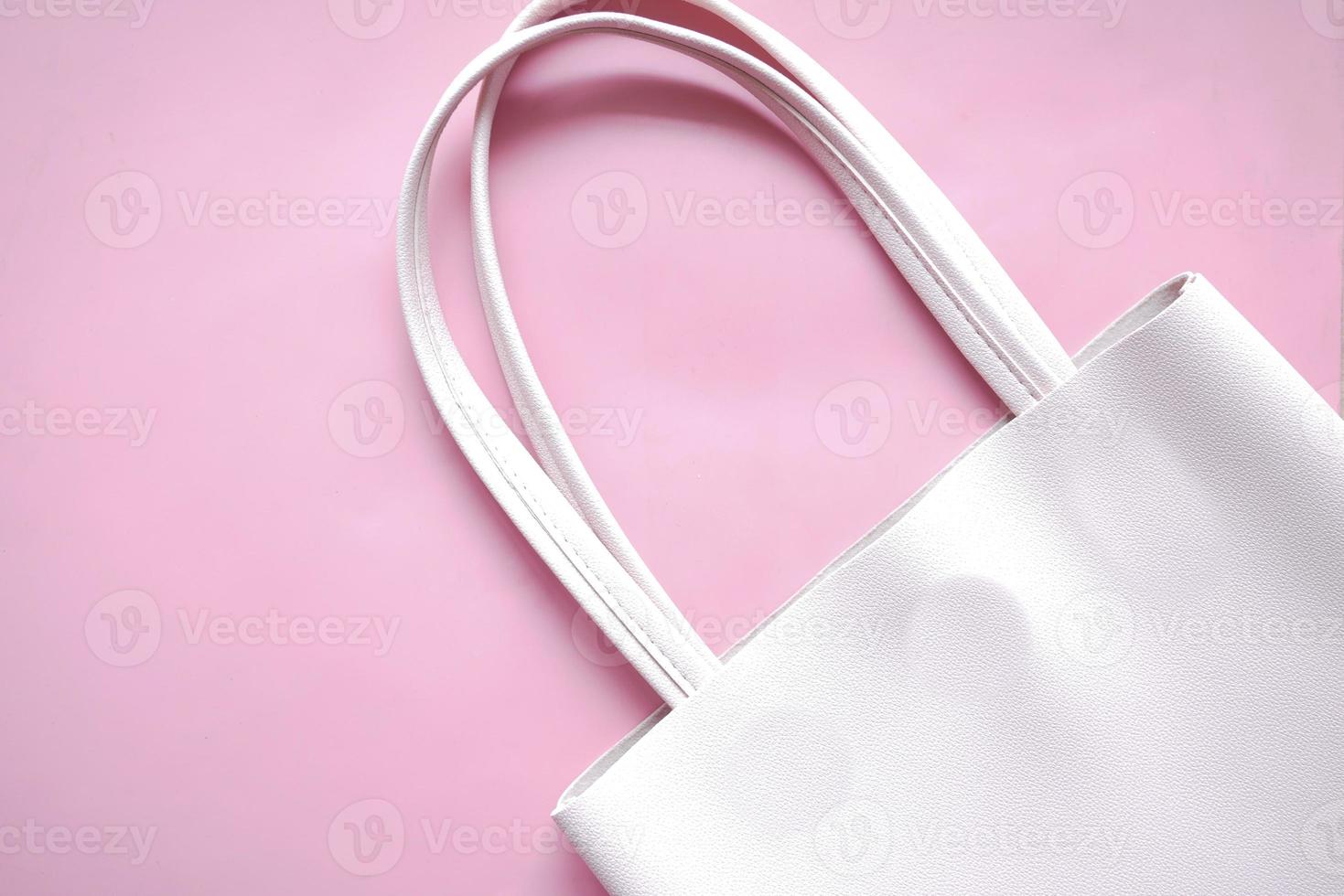 Cartera de mujer sobre fondo de color rosa, cerrar foto