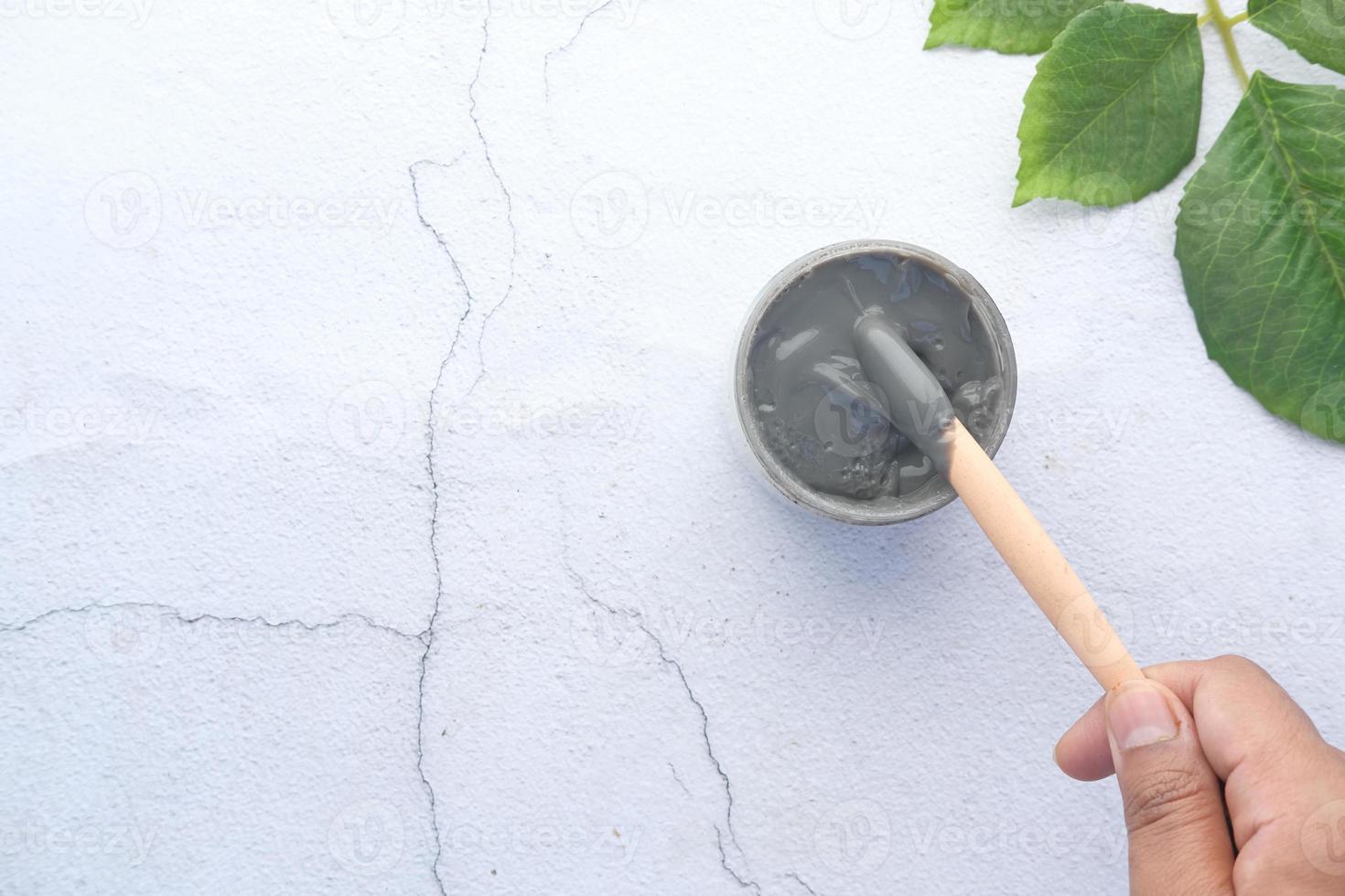 Bubble clay mask in container on white background photo