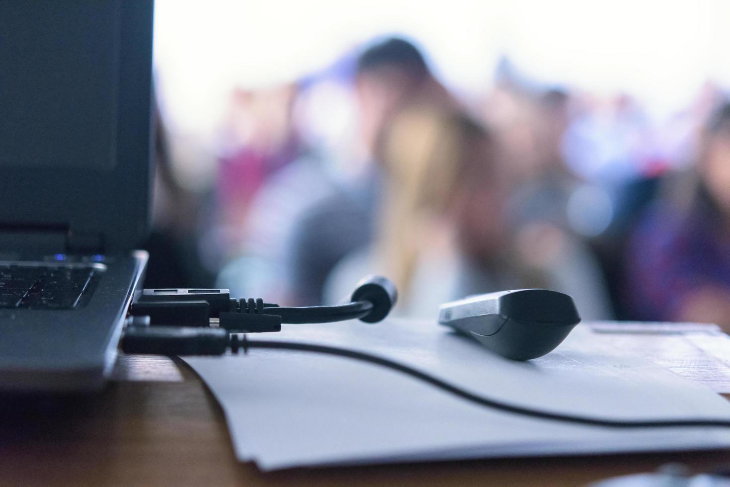 Laptop on Business presentation desk with blured people background bokeh. photo