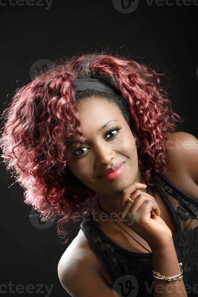 Beautiful black woman on black background. Studio shot photo