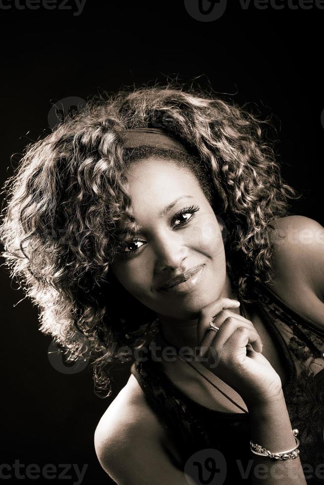 Beautiful black woman on black background. Studio shot photo