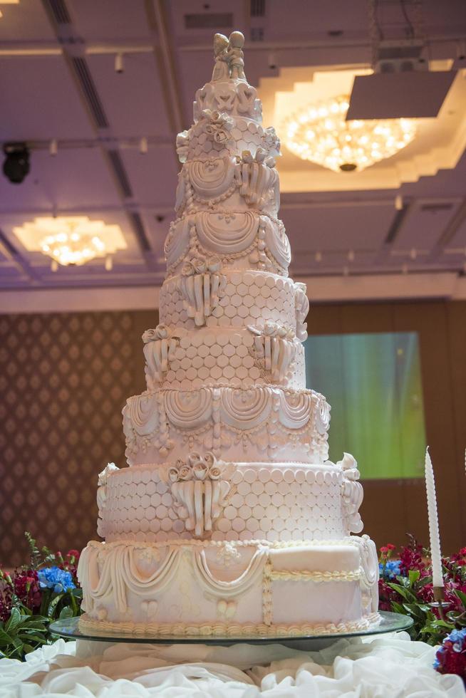 White wedding cake with red flower decorate photo