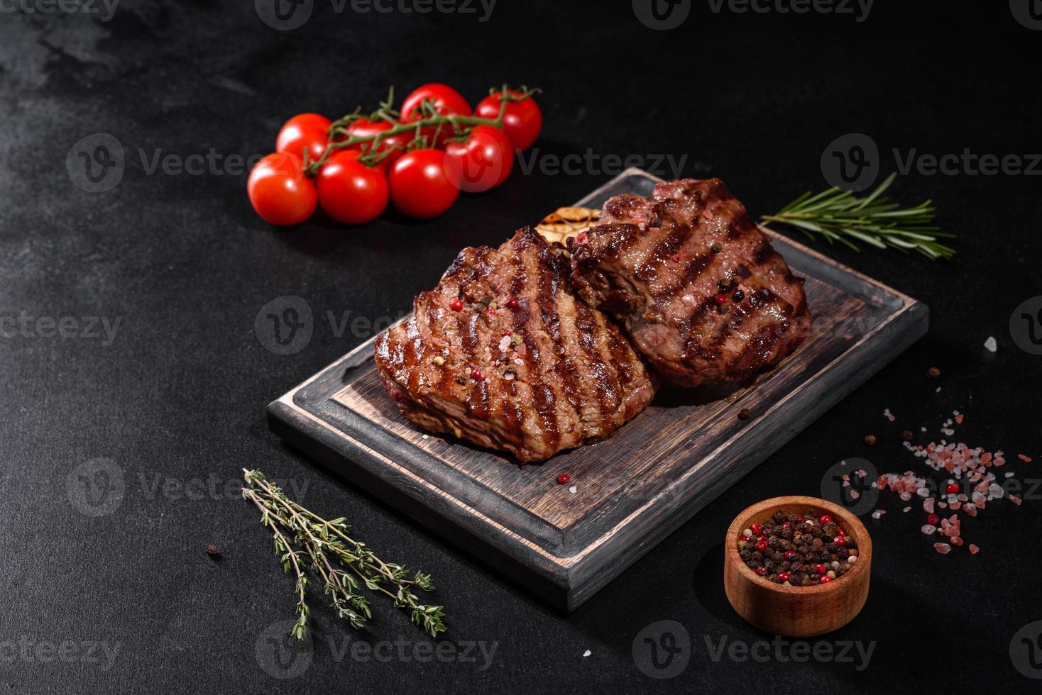 Fresh juicy delicious beef steak on a dark background photo