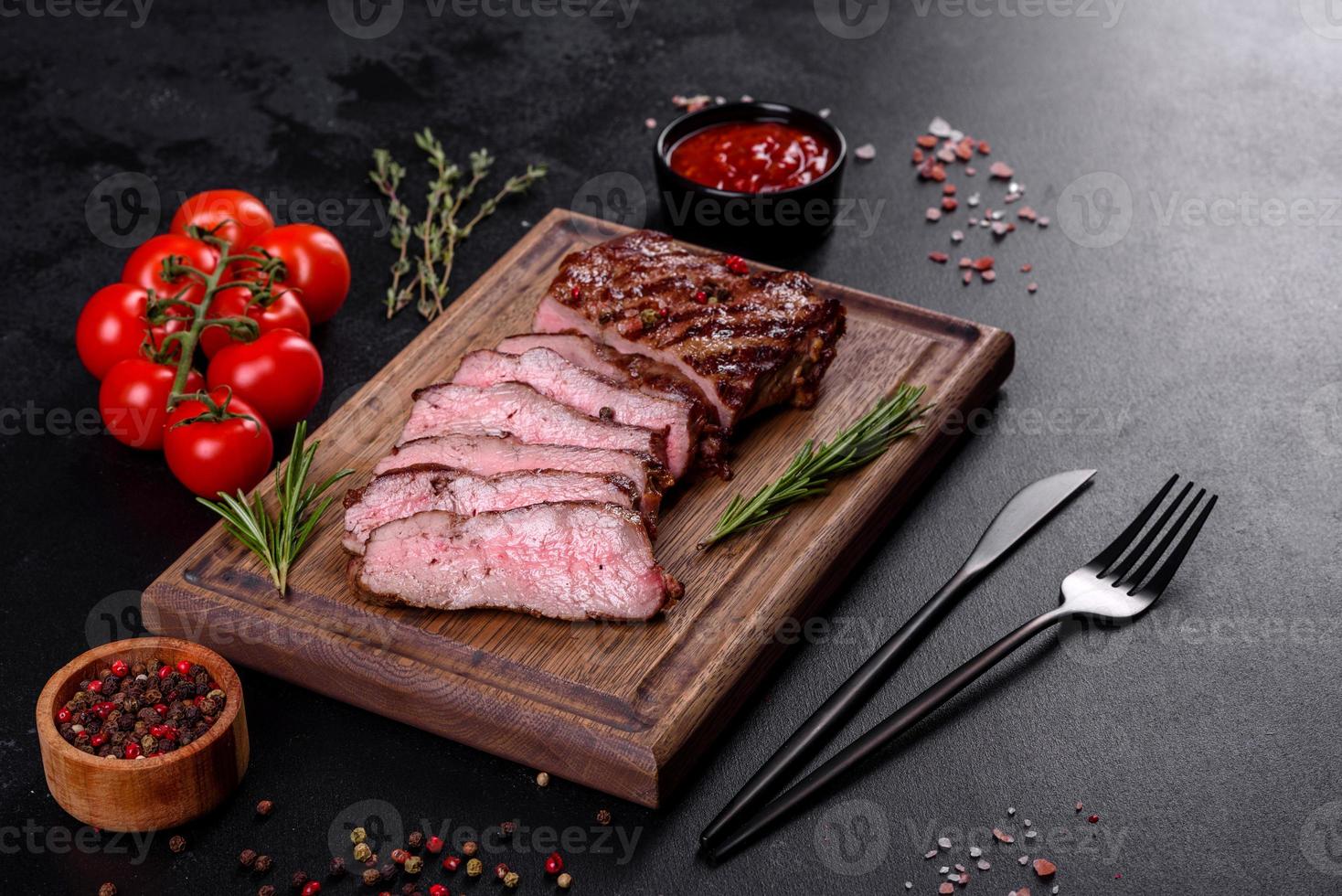 Fresh juicy delicious beef steak on a dark background photo