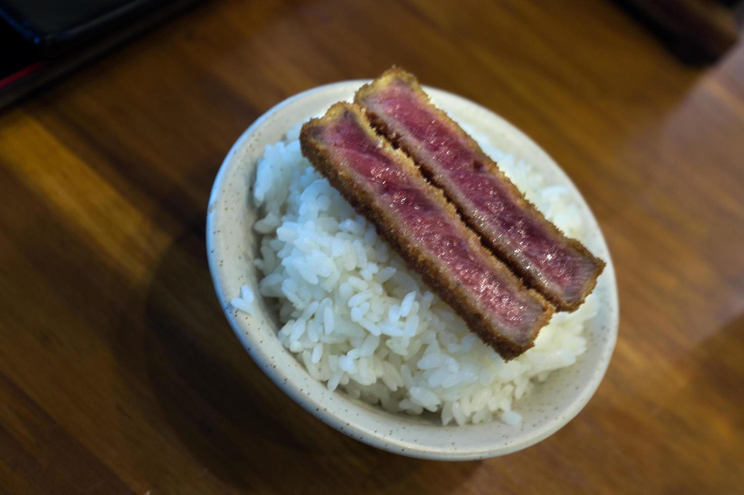 Fried crispy beef Gyukatsu steak served with rice photo