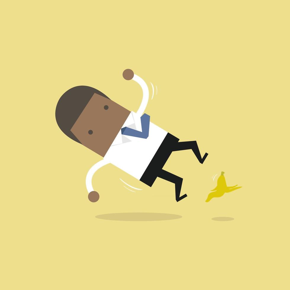 African businessman slipping on a banana peel and falling down. vector
