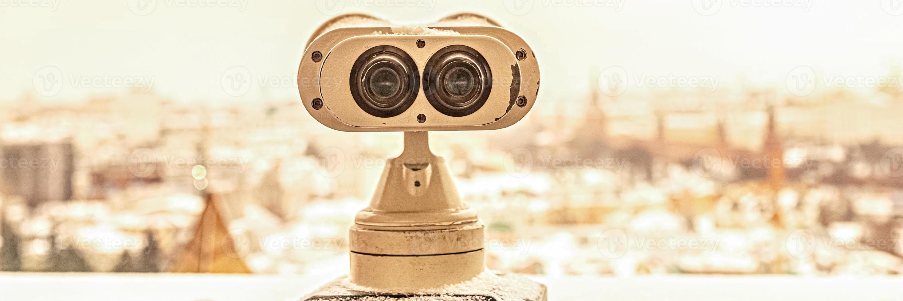 Coin-operated binoculars on the observation deck overlooking the city photo