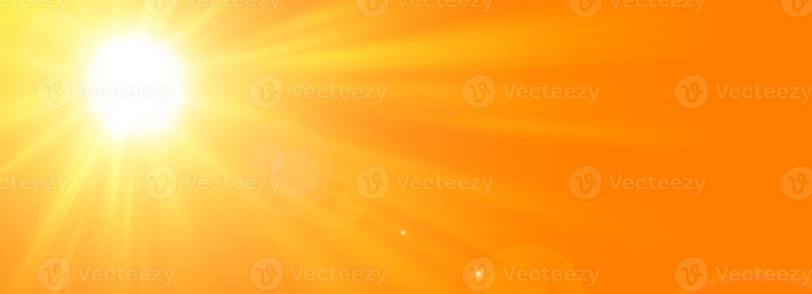 Sunny summer background with the bright sun on an orange background photo