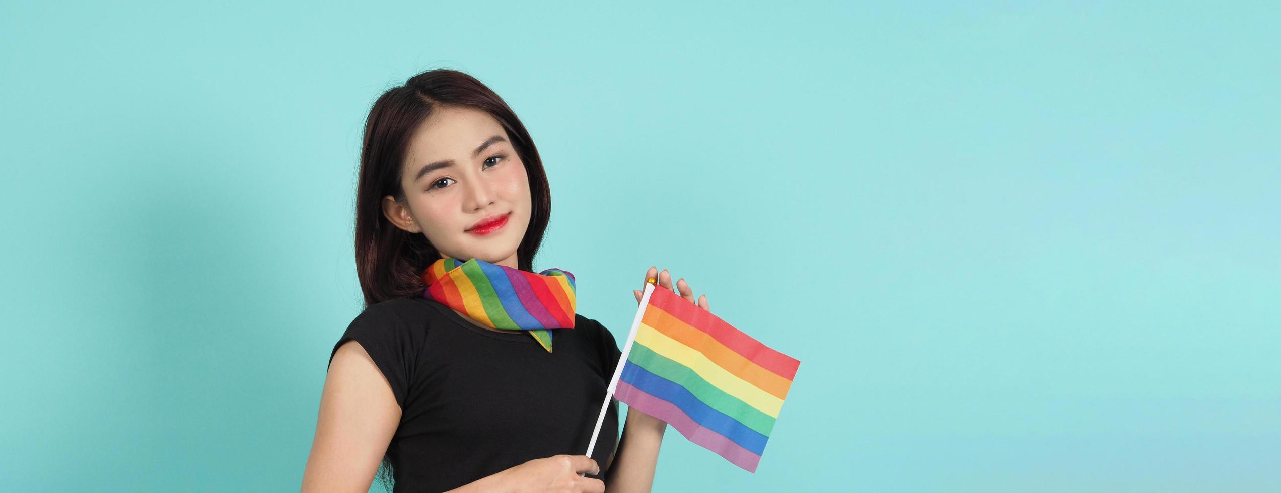 LGBTQ girl and pride flag. Sexy Lesbian girl and LGBTQ flag standing. photo