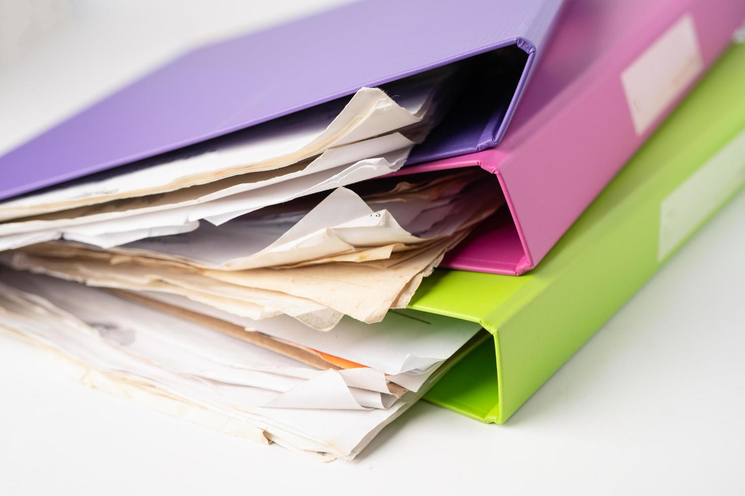 File Folder Binder stack of multi color on table in office. photo