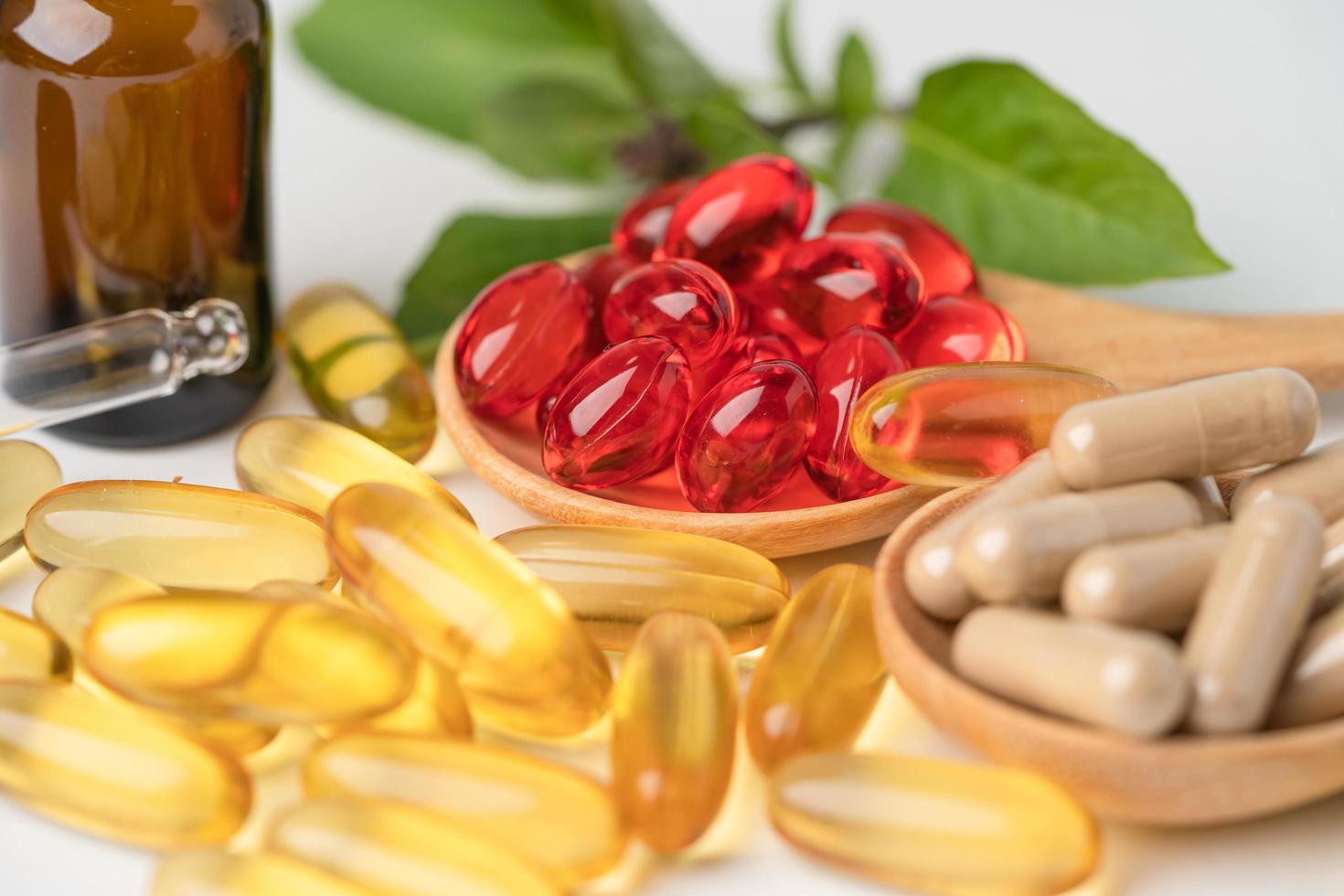 medicina alternativa cápsula orgánica a base de hierbas con vitamina e omega 3 aceite de pescado, mineral, medicamento con hojas de hierbas suplementos naturales para una vida sana y buena. foto