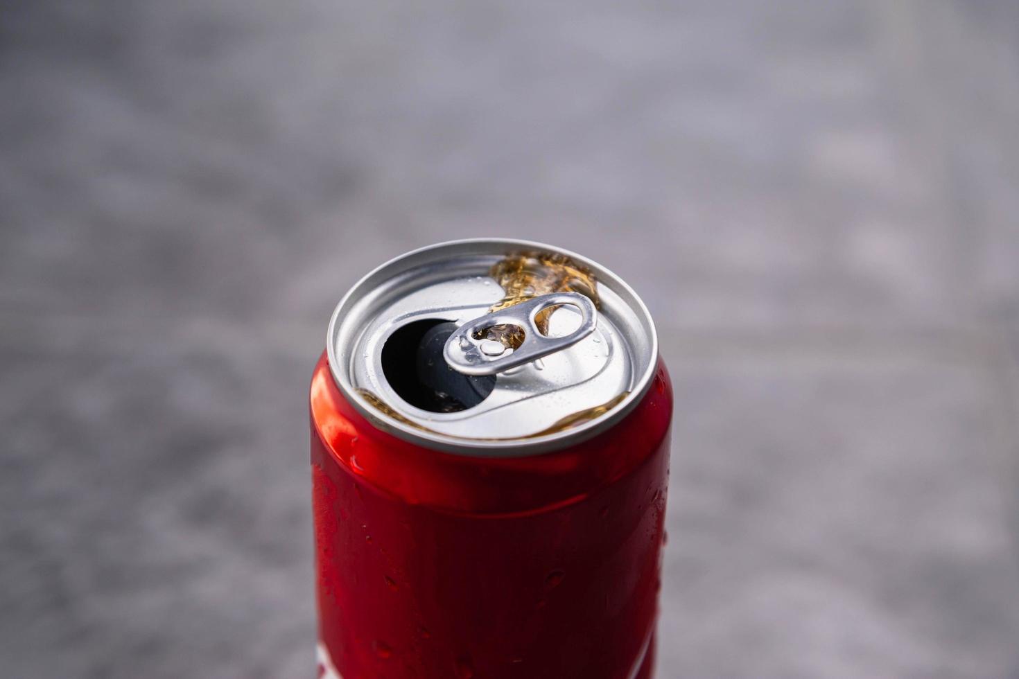 Red drink can and  Black sparkling water photo