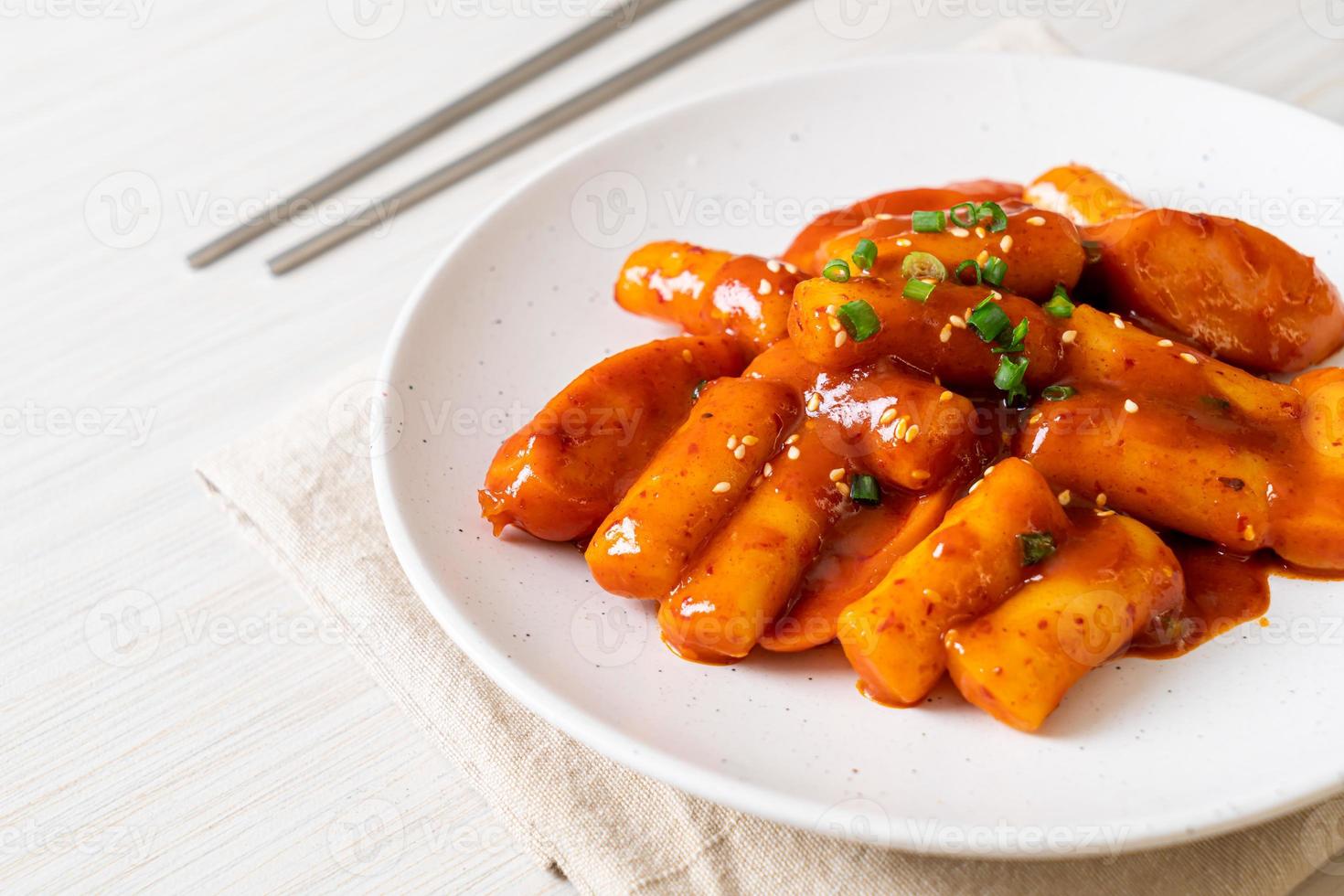 Korean rice cake stick with sausage in spicy sauce - Tteokbokki photo