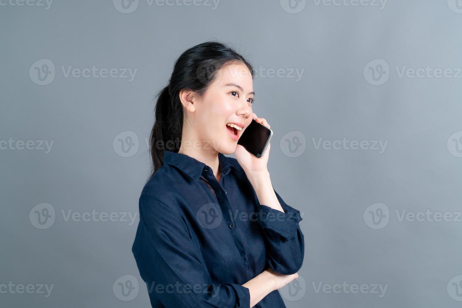 Asian woman using mobile phone talking business photo