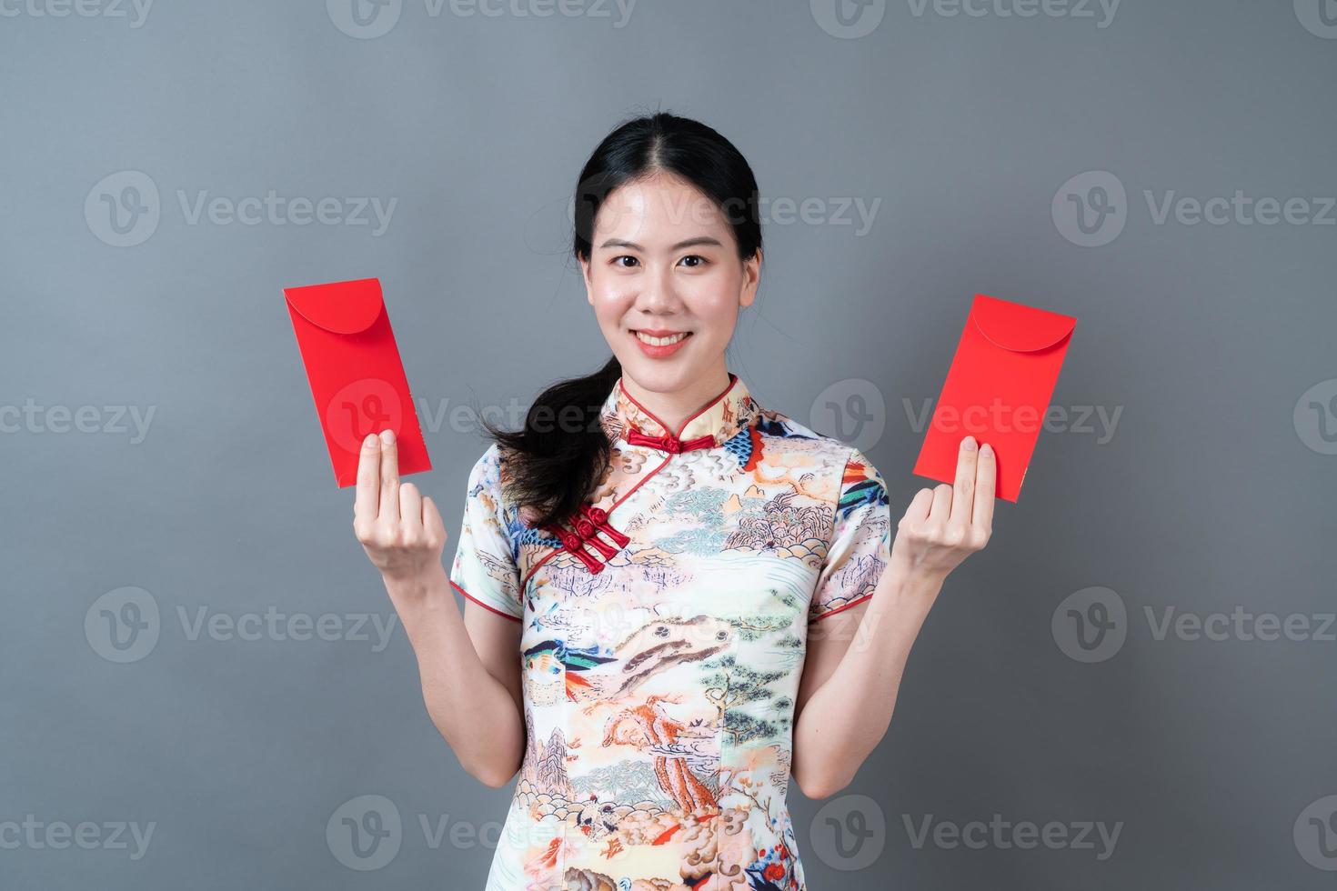 Asian woman wear Chinese traditional dress with red envelope or red packet photo