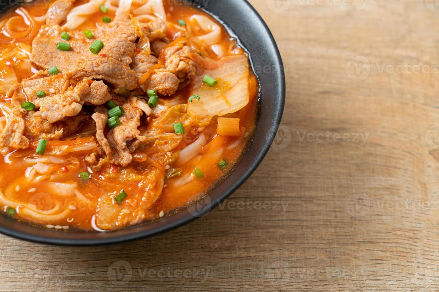 Korean udon ramen noodles with pork in kimchi soup photo