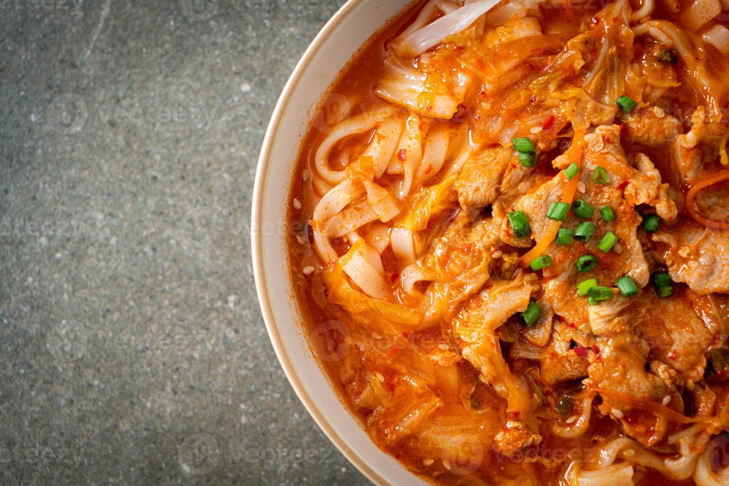 Korean udon ramen noodles with pork in kimchi soup photo