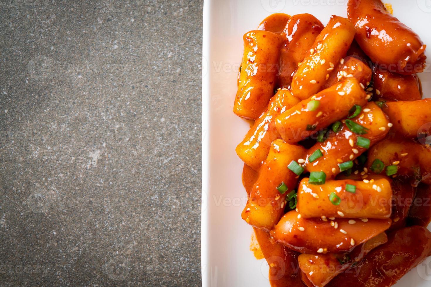 Korean rice cake stick with sausage in spicy sauce - Tteokbokki photo