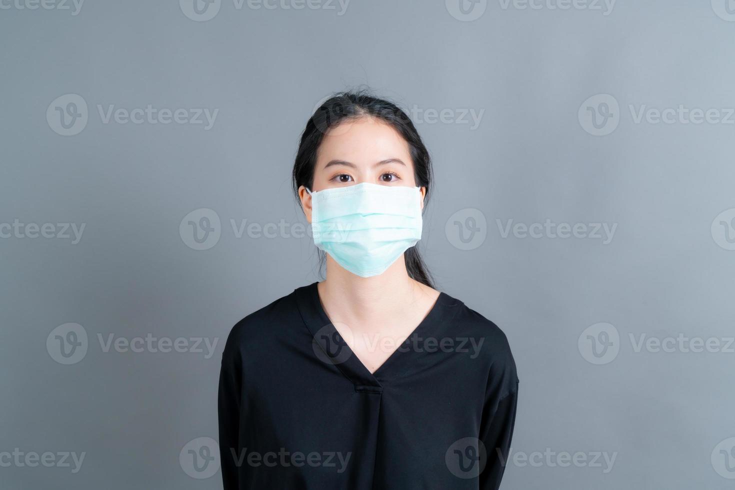 Asian woman wearing medical face mask protects filter dust pm2.5 anti-pollution, anti-smog, and COVID-19 photo