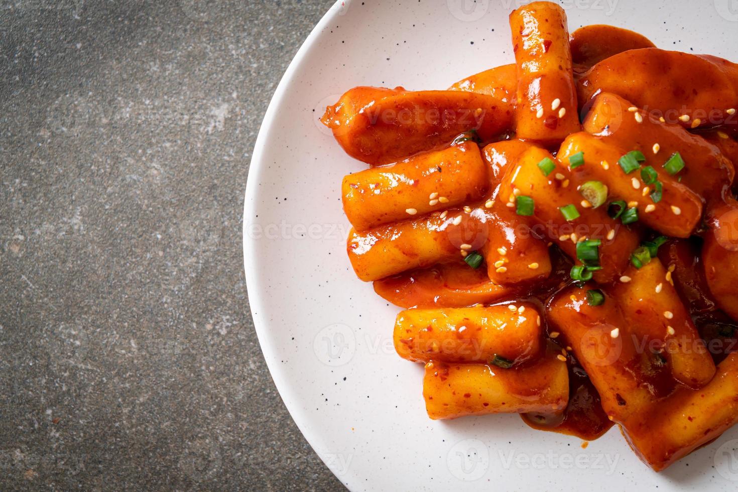 Korean rice cake stick with sausage in spicy sauce - Tteokbokki photo