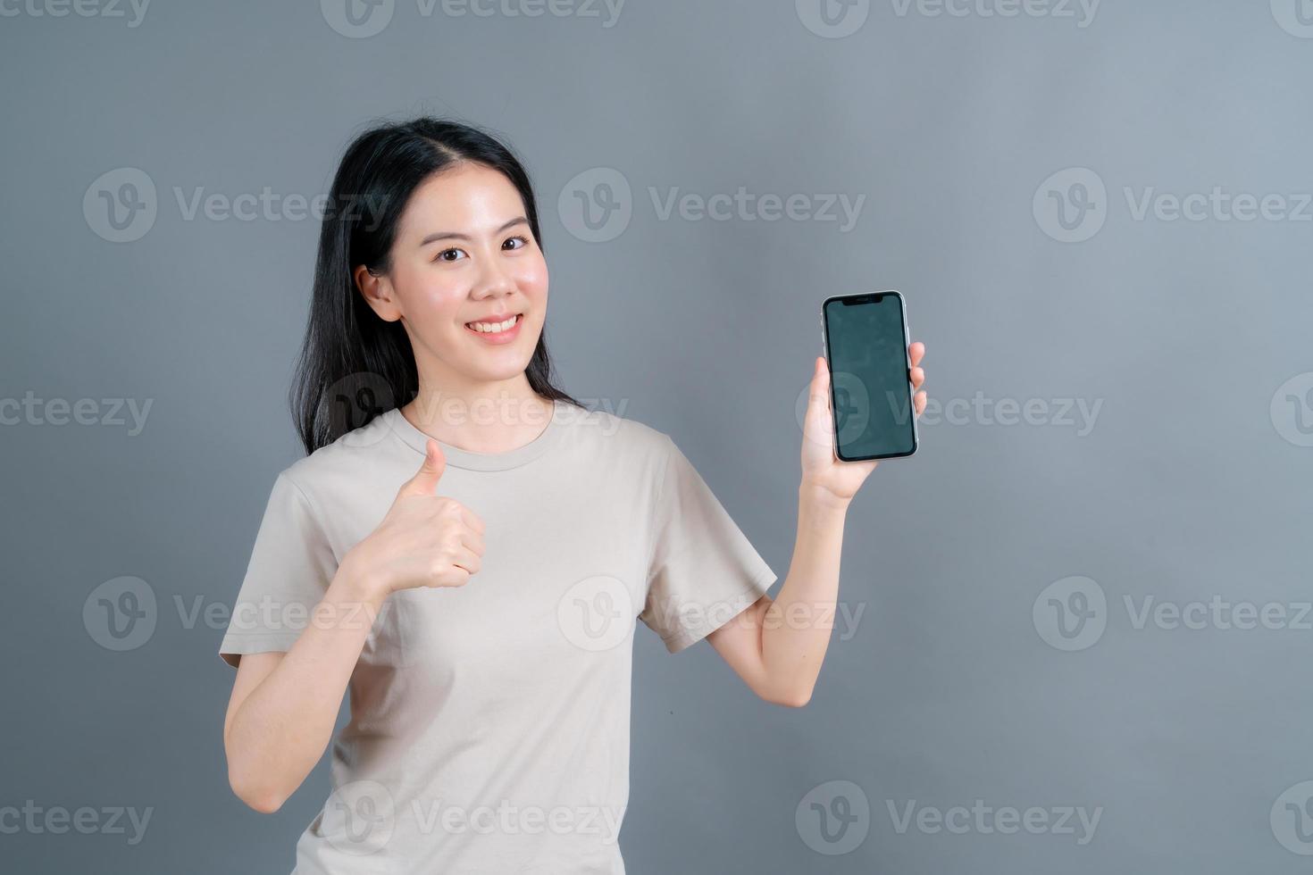 Asian woman using mobile phone applications, enjoying communicating distantly online in social network or shopping photo