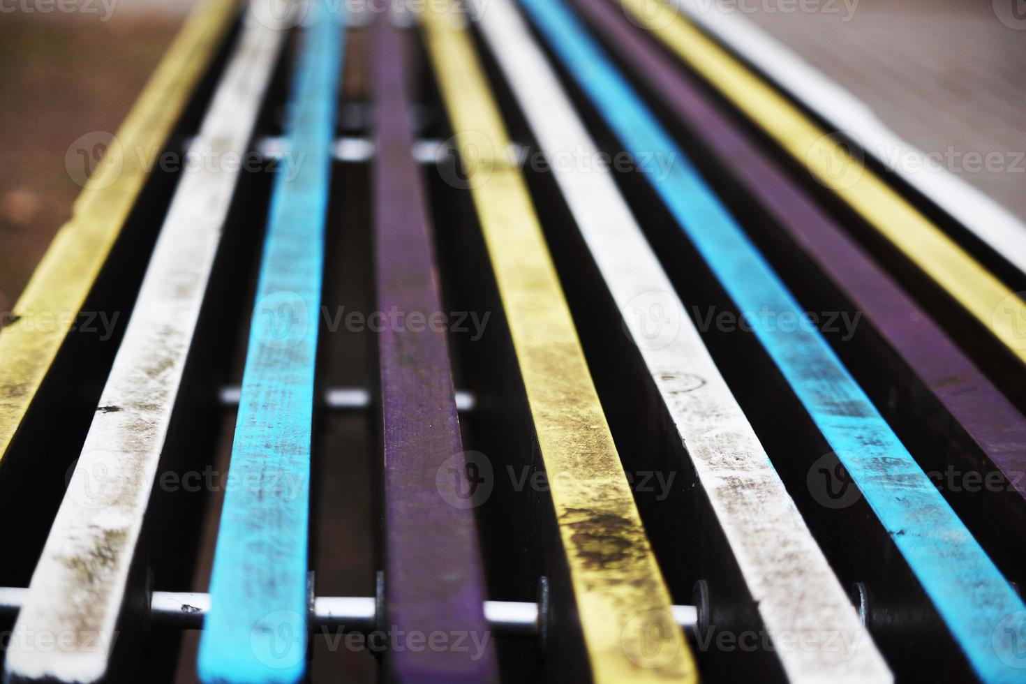 Colorful dirty painted bench planks bokeh background photo