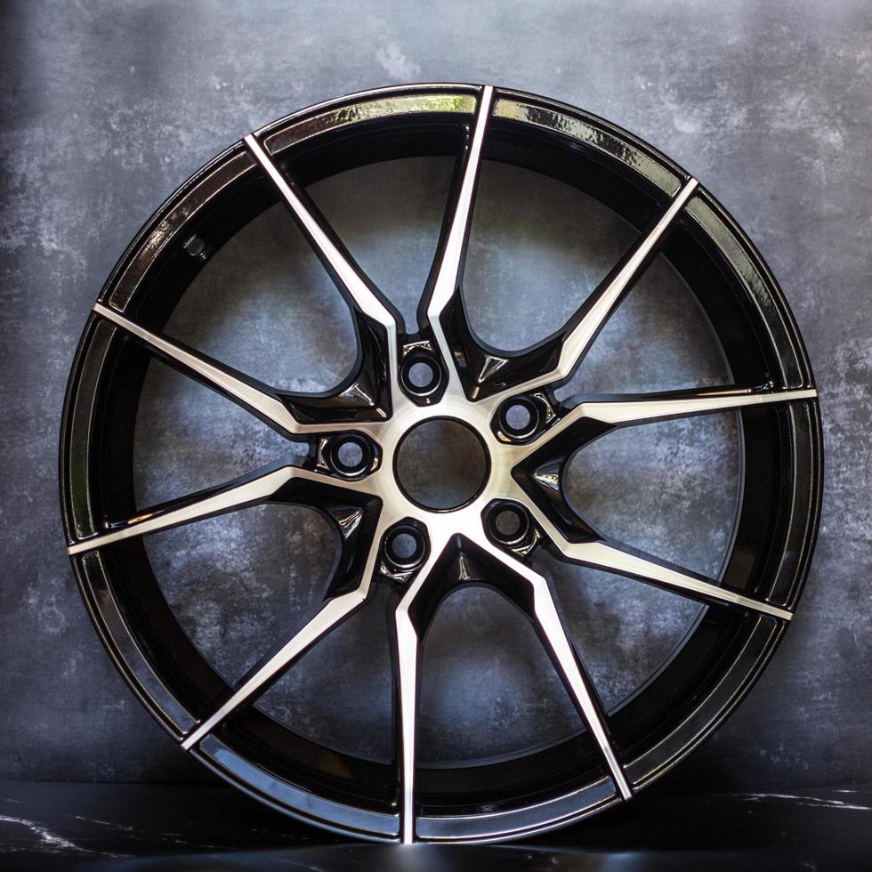 Luxury chrome alloy wheel in close-up as an automotive background.  Close up shot of a new car rim. photo