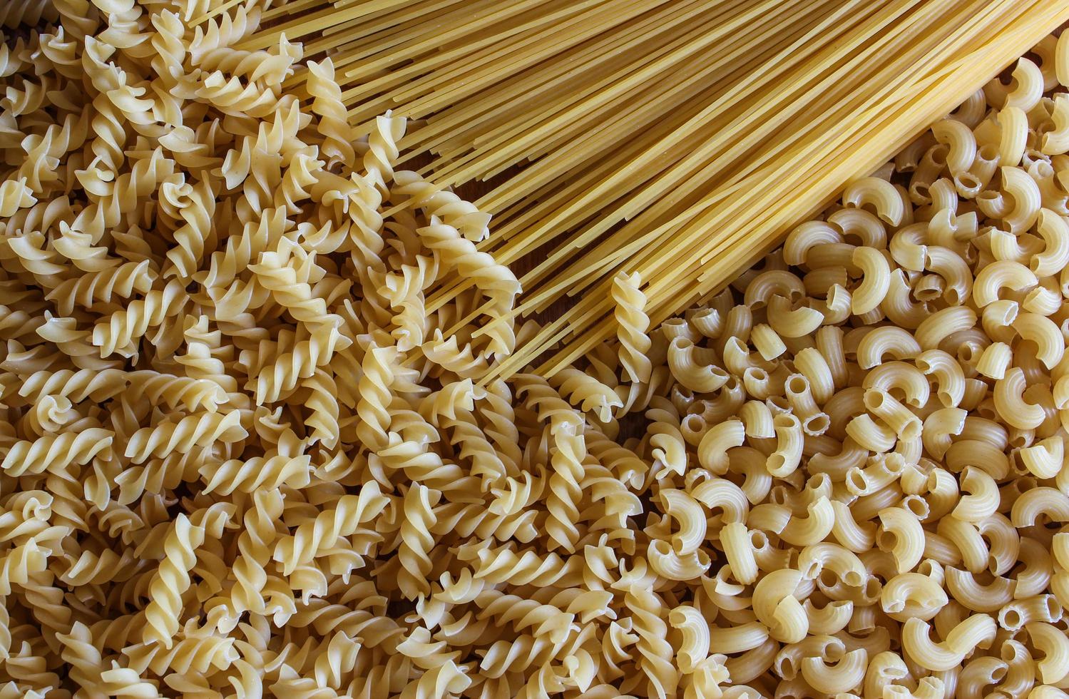 Variety of types and shapes of dry Italian pasta photo