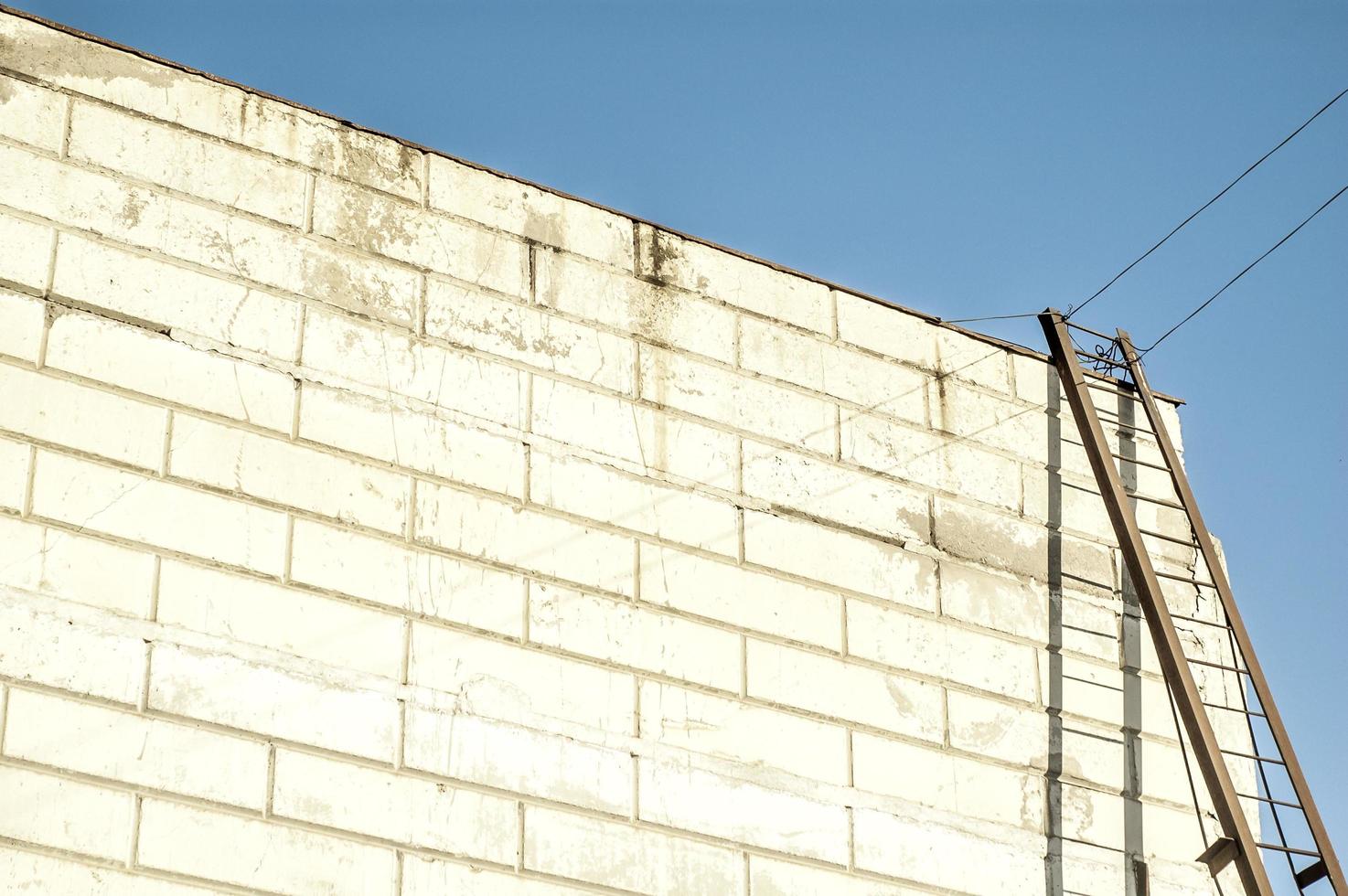 Modern warehouse building with an iron staircase casting shadow on te wahite wall photo