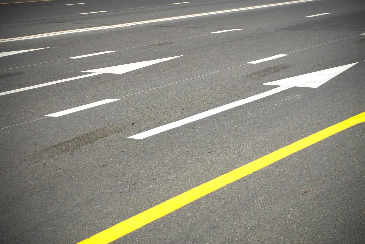 Asphalt road with lines and arrows photo