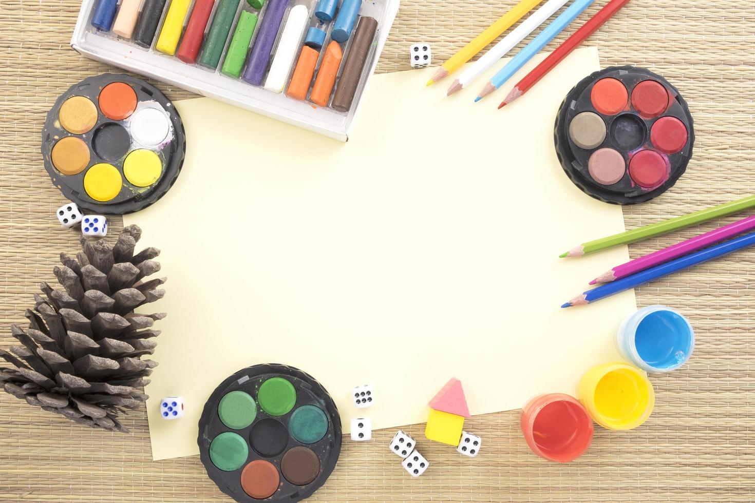 Conceptual flatlay with drawing tools and a pine cone photo