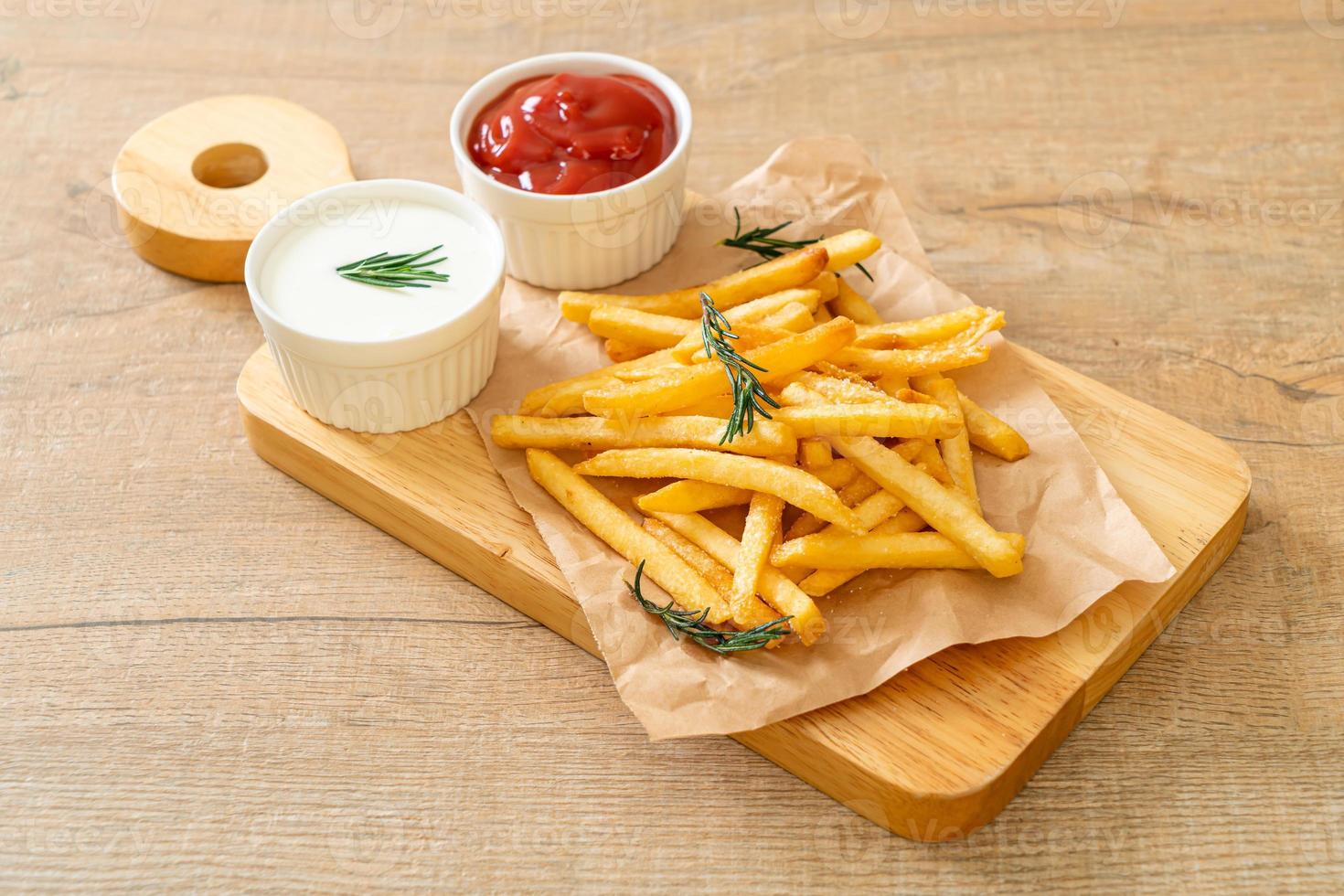 French fries with sour cream and ketchup photo