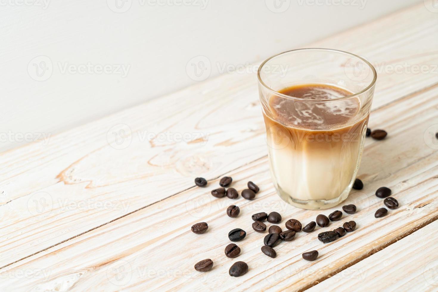 Dirty coffee, cold milk topped with hot espresso coffee shot photo