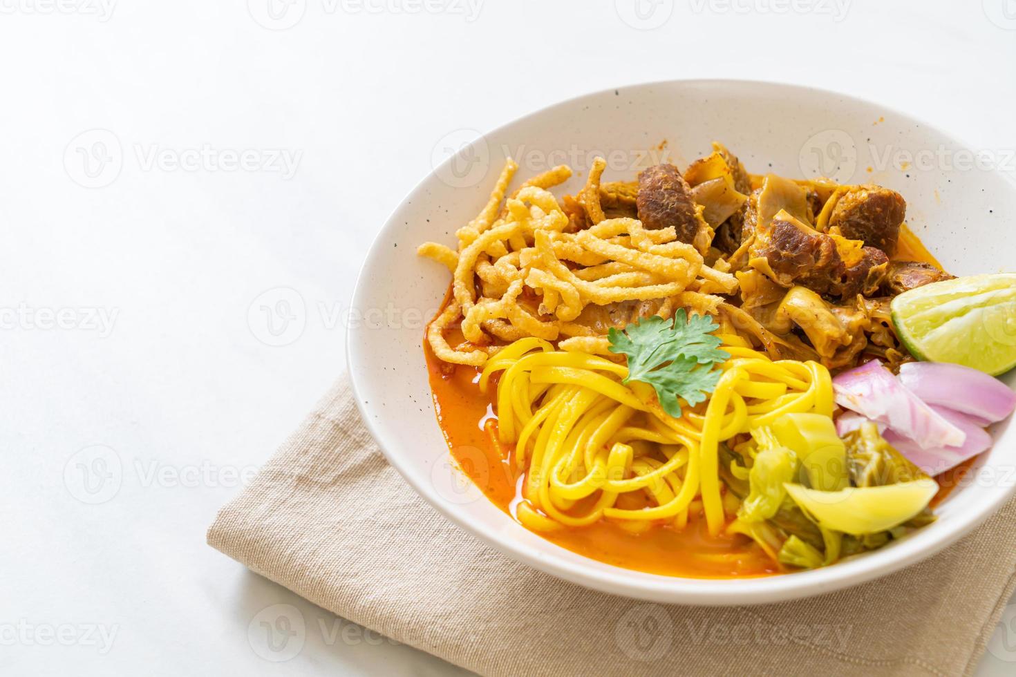 Northern Thai noodle curry soup with braised pork photo