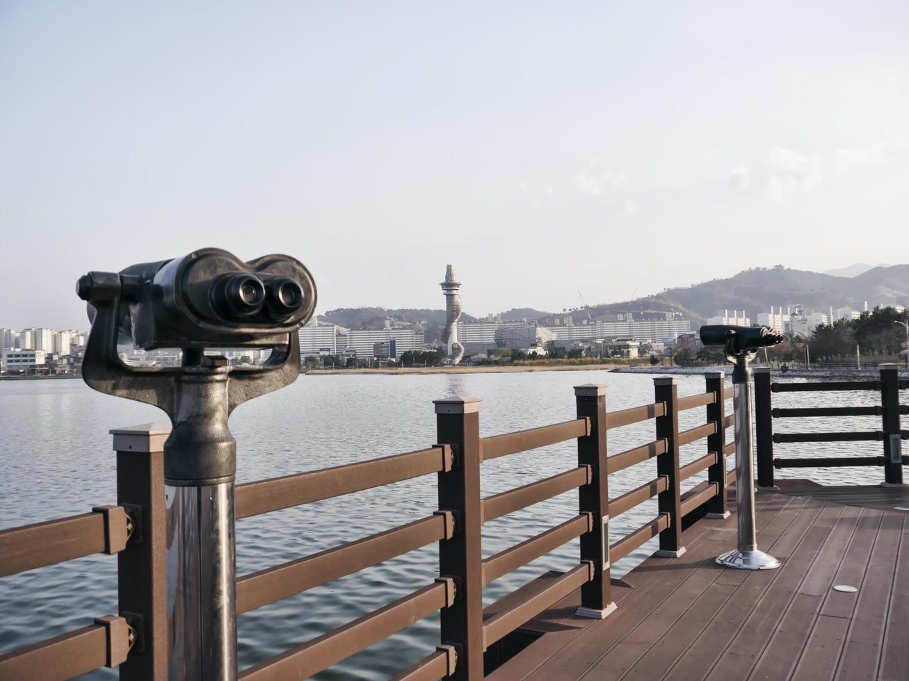 Observation binoculars on the pier and Sokcho city, South Korea photo