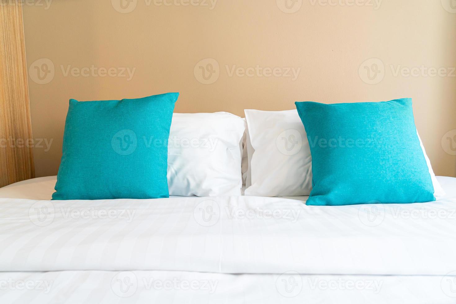 Beautiful and comfortable pillows decoration on bed in bedroom photo