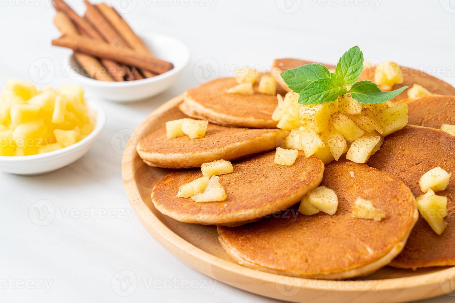 Apple pancake or apple crepe with cinnamon powder photo