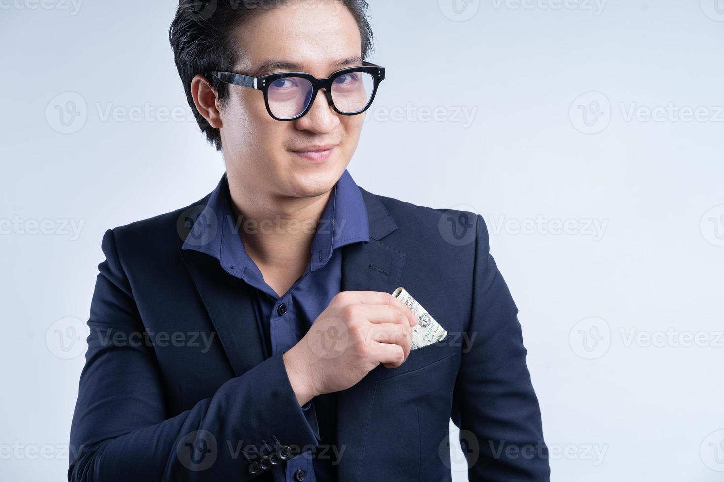 Portrait of Asian businessman holding one dollar photo